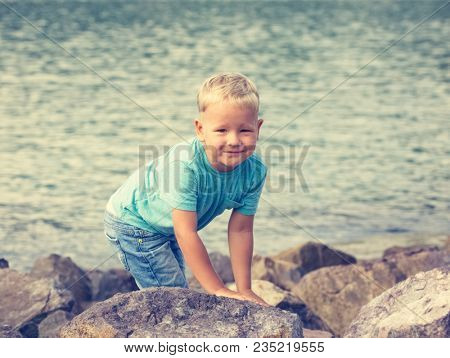 Cute caucasian boy at seaside. Leisure time