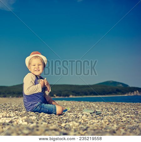 Cute caucasian boy at seaside. Leisure time