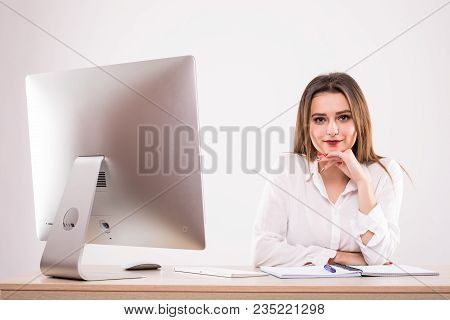 Beautiful Happy Businesswoman Using Computer While Sitting At The Desk At Office Isoltaed On The Whi