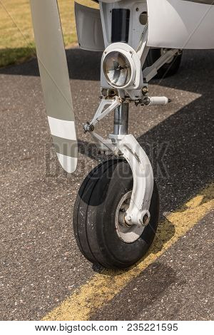 A Bow Of A Small Sport Aircraft. Wheel Of Airplane. Close Up Of Aircraft Wheel On Runway. Plane Whee