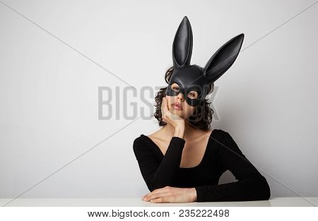 Sexy Beautiful Woman Posing In Lace Lingerie And Black Bunny Mask On White Background. Space For You