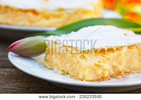 Homemade Cream Pie Made Of Two Layers Of Puff Pastry, Filled With Whipped Cream. Yellow Flower For A