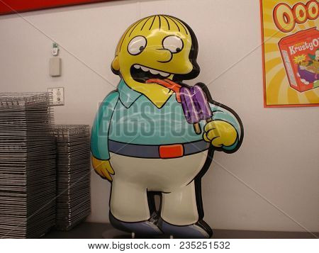 Ralph Wiggum Character Plastic Poster Licking A Purple Popsicle At A Seven Eleven Turned Into A Kwik
