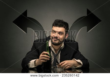 Drunk disappointed man sitting at table with arrows around