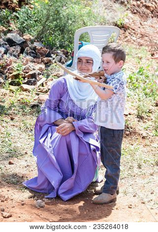 Goren, Israel, April 06, 2018 : A Participant In A Knight Festival Teaches A Visitor How To Shoot A 