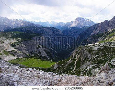 Stunning View Into The Deep Valley In Dolomits Mountains.