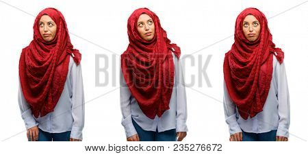 Arab woman wearing hijab making funny face fooling isolated over white background