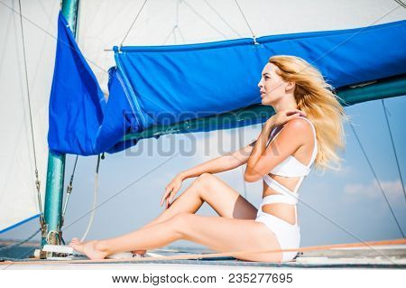 Woman Sitting On Sail Boat Or Yacht