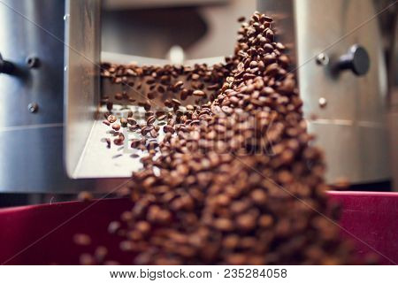 Image of falling coffee beans from roaster