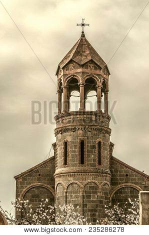 High Cylindrical Bell Tower Of St.mesrop Mashtots Church In The Village Of Oshakan The Background Of