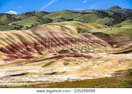 The Oregon Painted Hills. Bold Red Sandy Soil Makes Stripes Through The Hills, Alternating Red, Blac