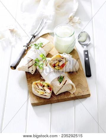 Chicken And Veggetable Salad Wraps With Yogurt Sauce.