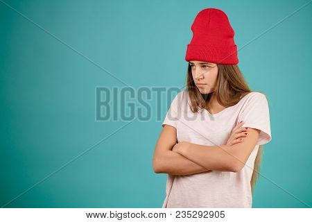Side View Closeup Image Of Aggrieved Injured Young Female With Crossed Arms. Woman Is In High Dudgeo