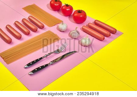 A Lot Of Raw Sausages With Pasta And Vegetables On Pink And Yellow Background, Top View. Still Life.