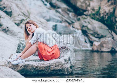 Beautiful young woman relaxing in the nauture on the spring day