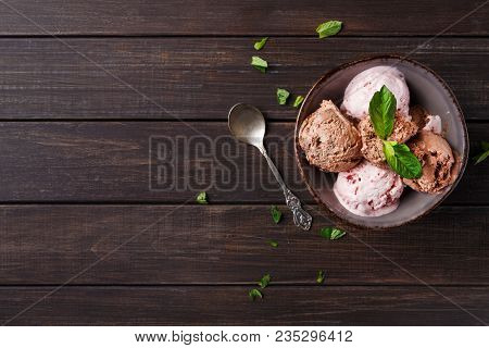 Portion Of Chocolate And Berry Ice Cream Scoops With Spoon On Rustic Wooden Background, Copy Space. 