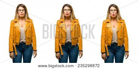 Beautiful young woman making funny face fooling over white background