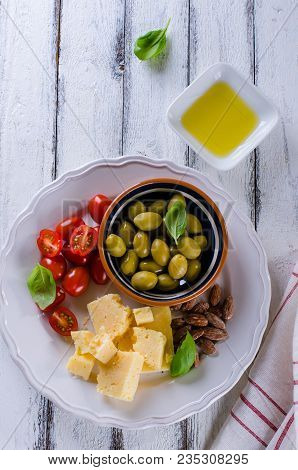 Antipasti Plate Of Parmesan, Cherry Tomatoes, Olives And Almonds