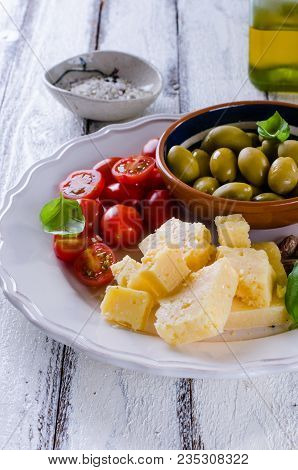 Antipasti Plate Of Parmesan, Cherry Tomatoes, Olives And Almonds