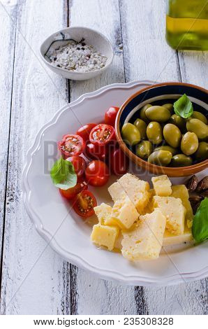 Antipasti Plate Of Parmesan, Cherry Tomatoes, Olives And Almonds