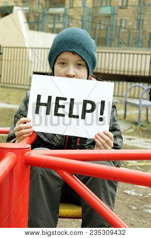 A Lonely Orphan Child On The Playground, Asking For Help, A Cold And Dreary Time Of Year Without Par