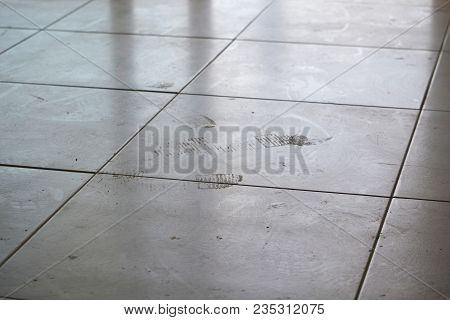 Dirty Footprints On White Tile On The Floor. Dirty Dusty Floor