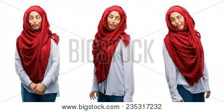 Arab woman wearing hijab making funny face fooling isolated over white background