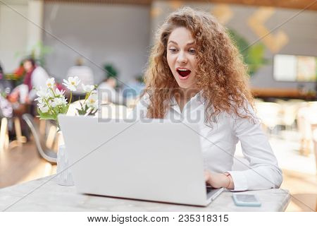 Surprised Attractive Female Student Works On Laptop Computer, Shocked As Has Deadline For Making Dip