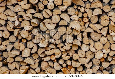 Material For Heating The House. Preparation Of Firewood For The Winter. Background Of Firewood. A Pi