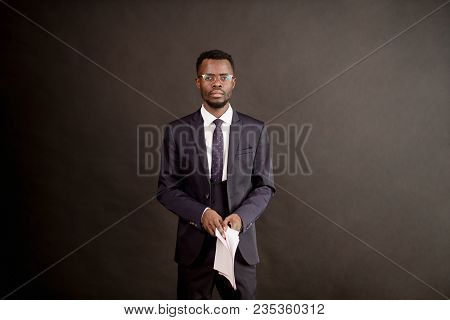 Serious Black Guy With Contract On His Hands. Tiredness Becauce Of Paper Work.