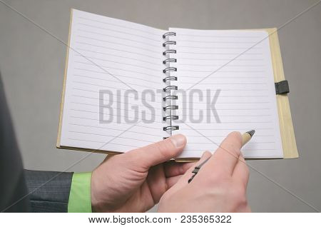 Businessman Holds In Hand A Note Pad With Pen. To Do List Template. Goals Or Business Tricks. Busine