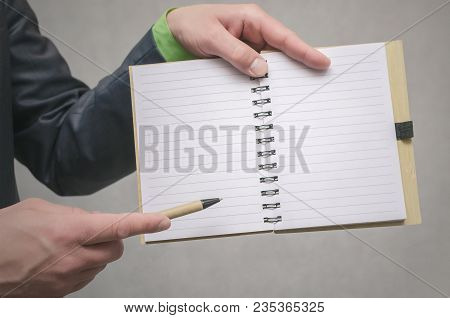 Businessman Holds In Hand A Note Pad With Pen. To Do List Template. Goals Or Business Tricks. Busine