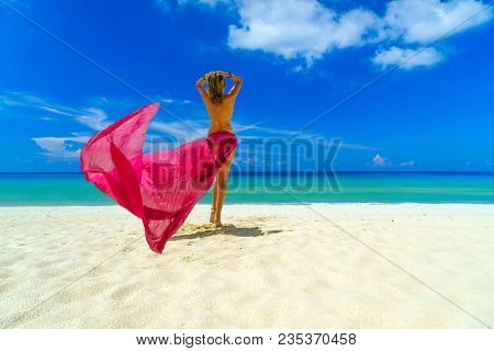 Woman with pink sarong on the tropical beach, Luxury beach travel vacation 