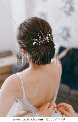 Morning Preparation Newlyweds For The Wedding. A Young Brunette Bride With A Beautiful Hairstyle And