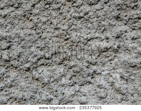A Wall Covered With Gray Cement Or Plaster, A Texture With High Relief, The Exterior Decoration Of T