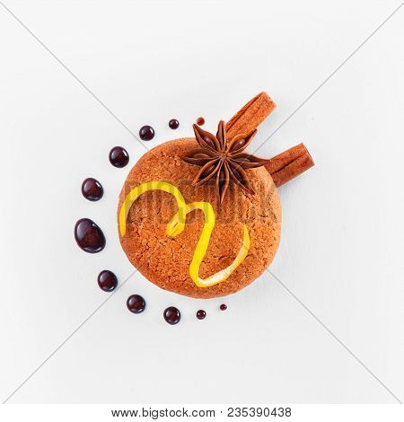 Cookie Decorated With Lemon Zest, Chocolate Drops, Cinnamon And Anise Star On A White Background. Pa