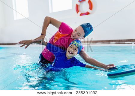 Boy Having A Swimming Lesson With Instructor