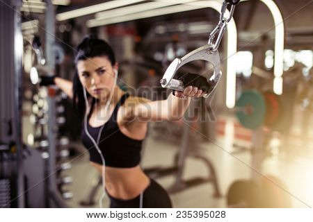 Fit Woman Exercise With Cable Crossover In Gym. Focus On Girl Hand. Selective Focus