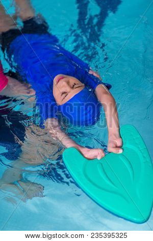 Boy Having A Swimming Lesson With Instructor