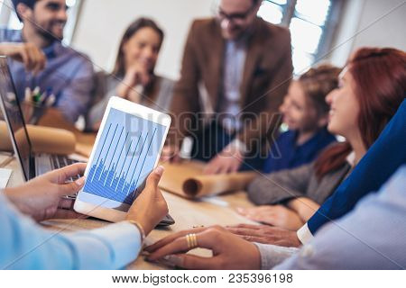 Business, Technology And Office Concept - Business Team On Meeting In Modernoffice Interior And Work