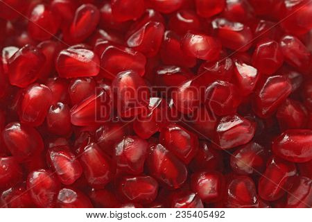 Red Background Of Grain Red Grenades. Big Ripe Red Granets Or Garnets. Fruits Of Red Ripe Pomegranat