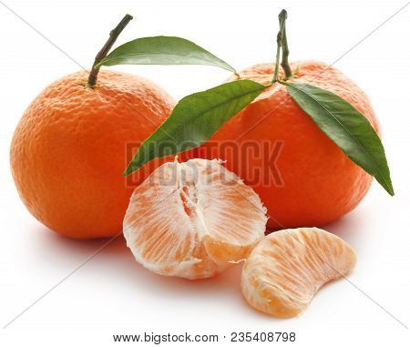 Fresh Orange With Green Leaves Over White Background