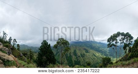 View From Ella Rock On Small Adams Peak In Sri Lanka. Green Mountains And Gray Sky