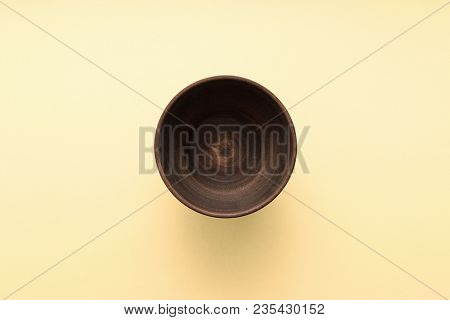 Empty Brown Plate On Pastel Yellow Background, Top View, Flat Lay