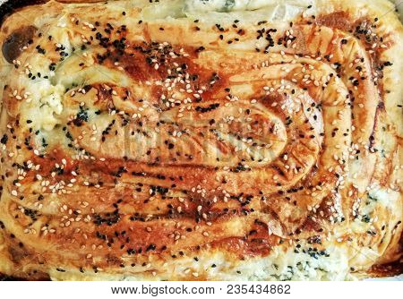 Close-up Pattern Of Traditional Bulgarian Home-baked Banitsa (pie With Cheese And Eggs). Food Backgr