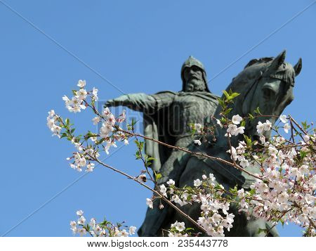 Russian Spring. Cherry Blossoms And A View Of The Monument To Prince Yuri Dolgoruky In Moscow - The 