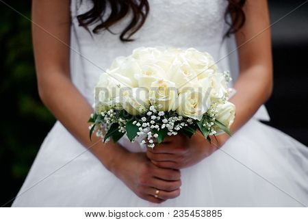 Beautiful Bride Holds Wedding Bouquet