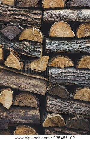 Firewood In Woodpile, Prepared For Winter. Pile Of Firewood. The Firewood Background. A Stack Of Nea