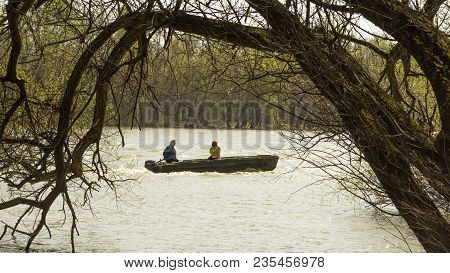 Fisherman And His Wife In The Boat On Danube River Near Town Of Leanyfalu In Hungary.