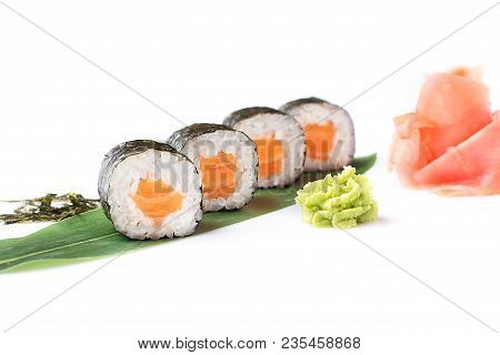 Delicious Fresh Mini-rolls With Salmon On A Banana Leaf. Sushi Rolls On A White Background With Ging